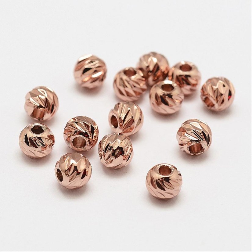 Texturált sárgaréz gyöngy - rózsaszín, 5,8x5 mm